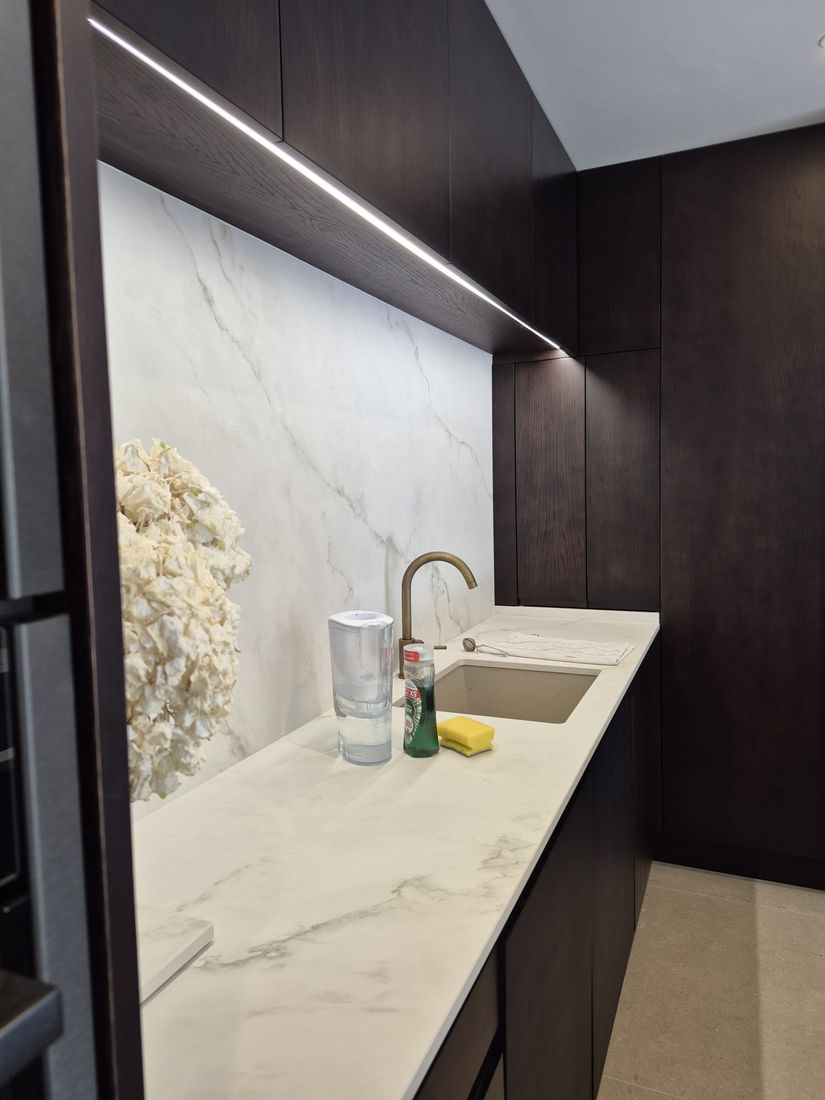 Linear LED strip lighting fitted under kitchen wall units